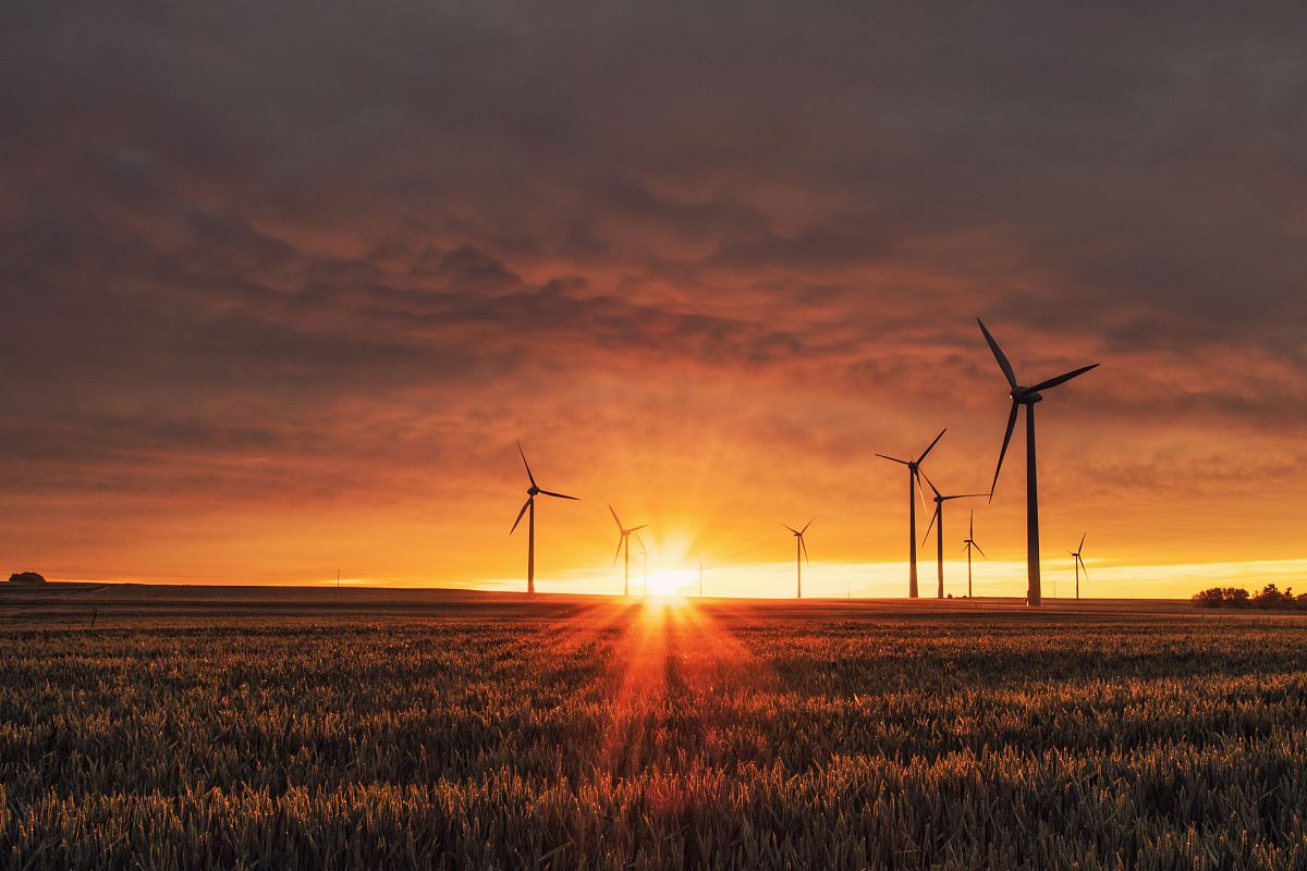 windmill on grass field during golden hour